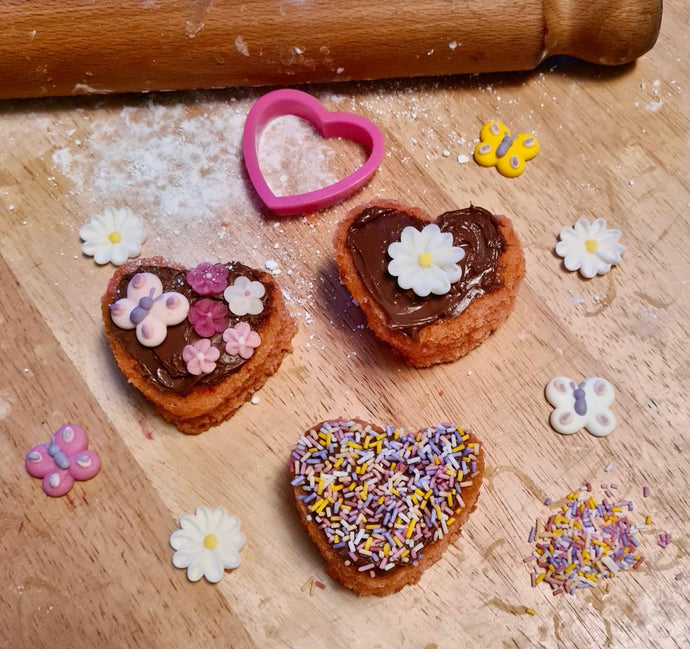 Chocolate topped, mini strawberry heart cakes